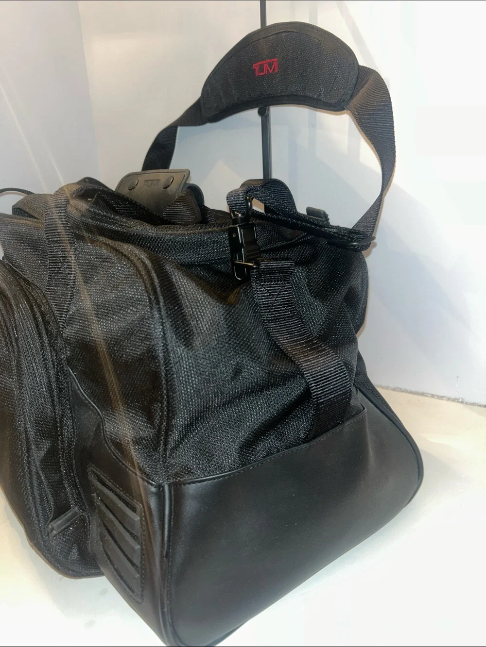Tumi Black Duffel Bag with Red Logo Accent